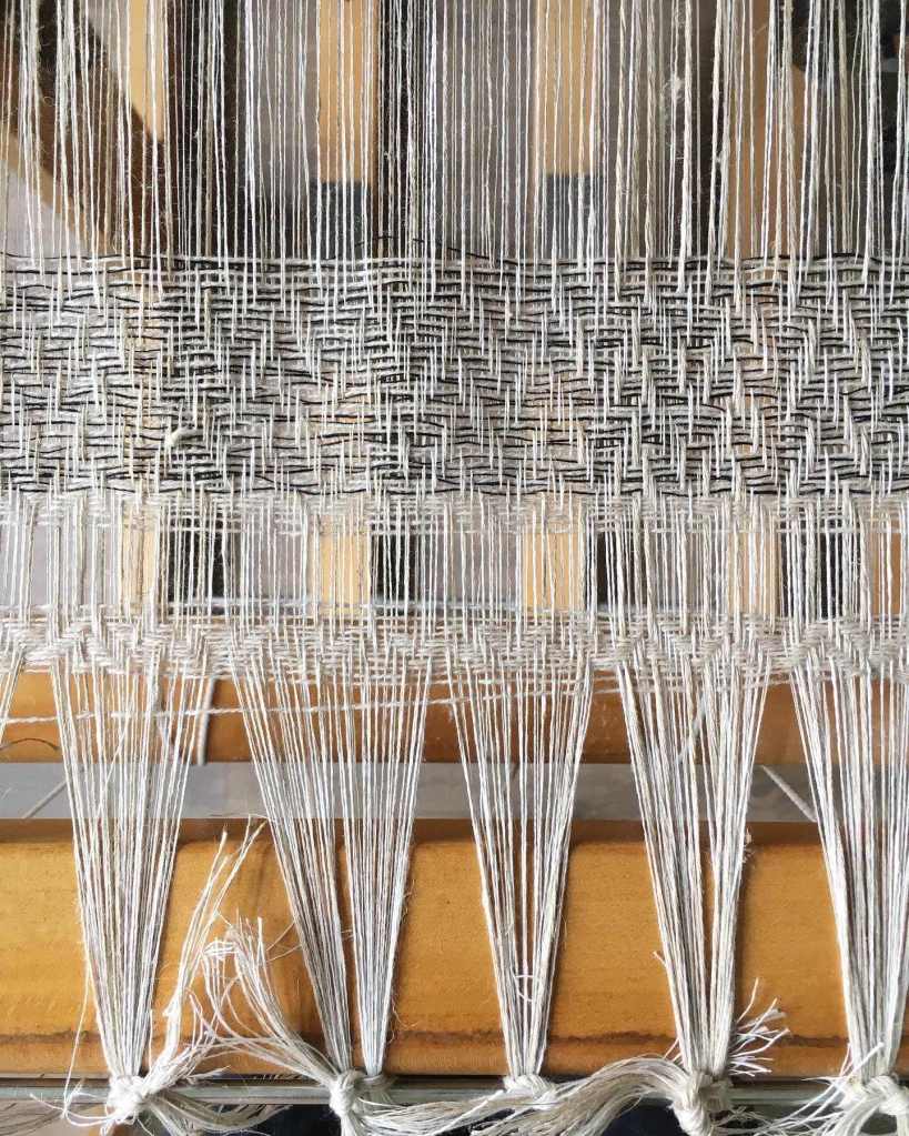 Linen warp on loom and starting to weave