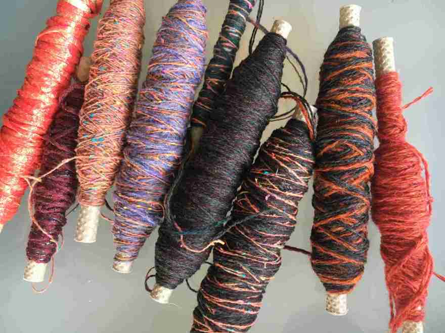 Yarns on bobbins for commissioned scarf