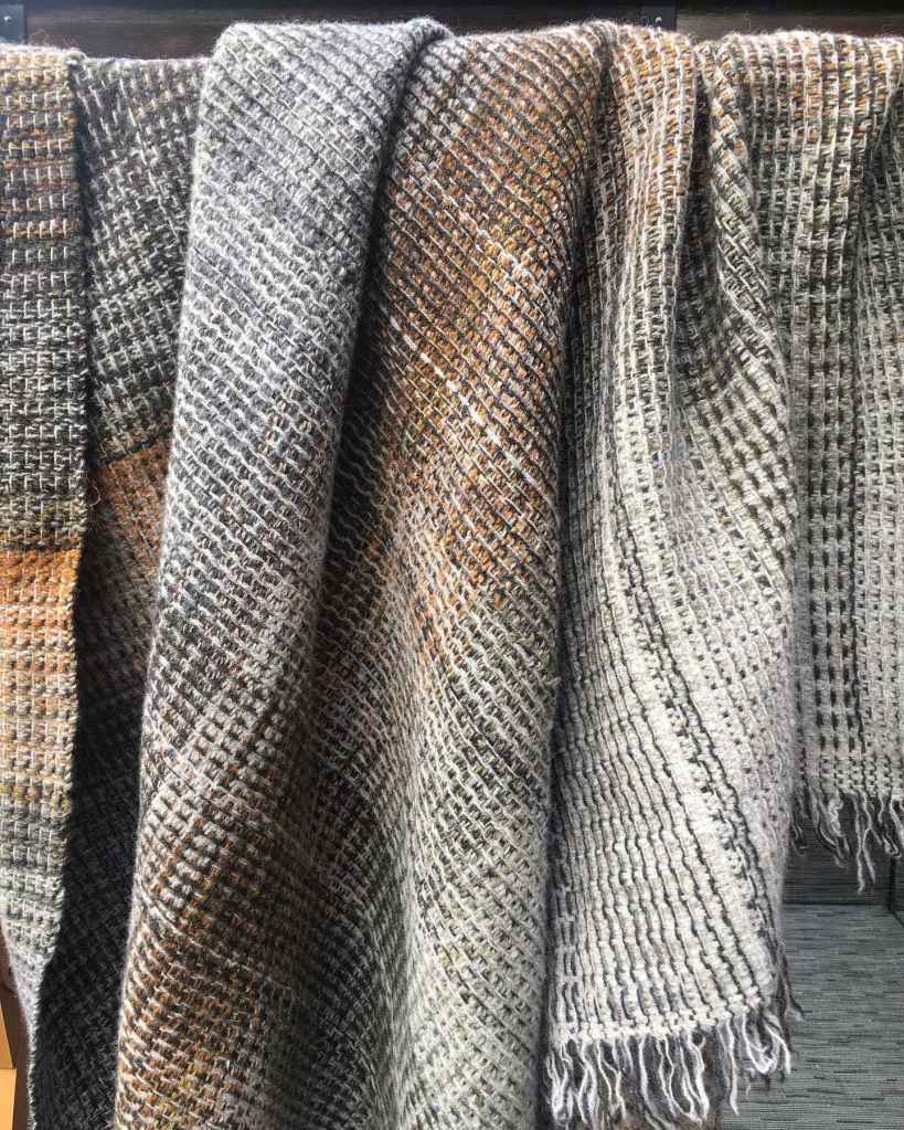 Handwoven throw full view hanging on rail