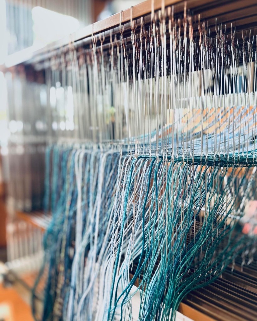 Threaded heddles on loom