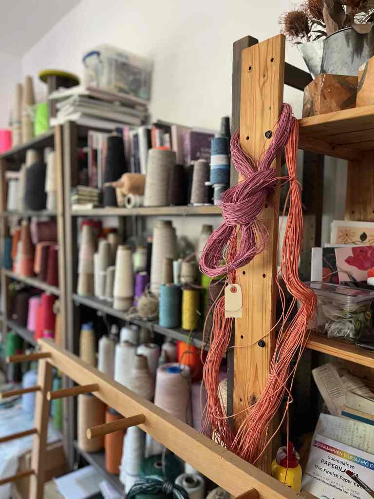 Studio view of shelves containing yarns