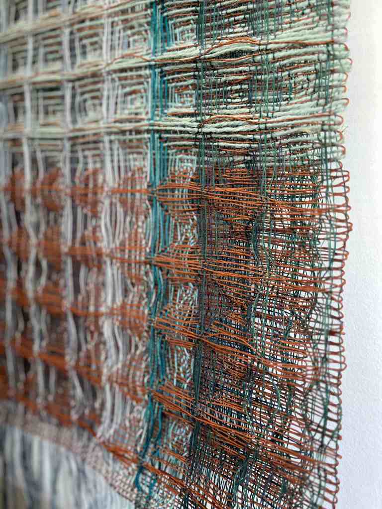 Rust and aqua paper and jute wall hanging
