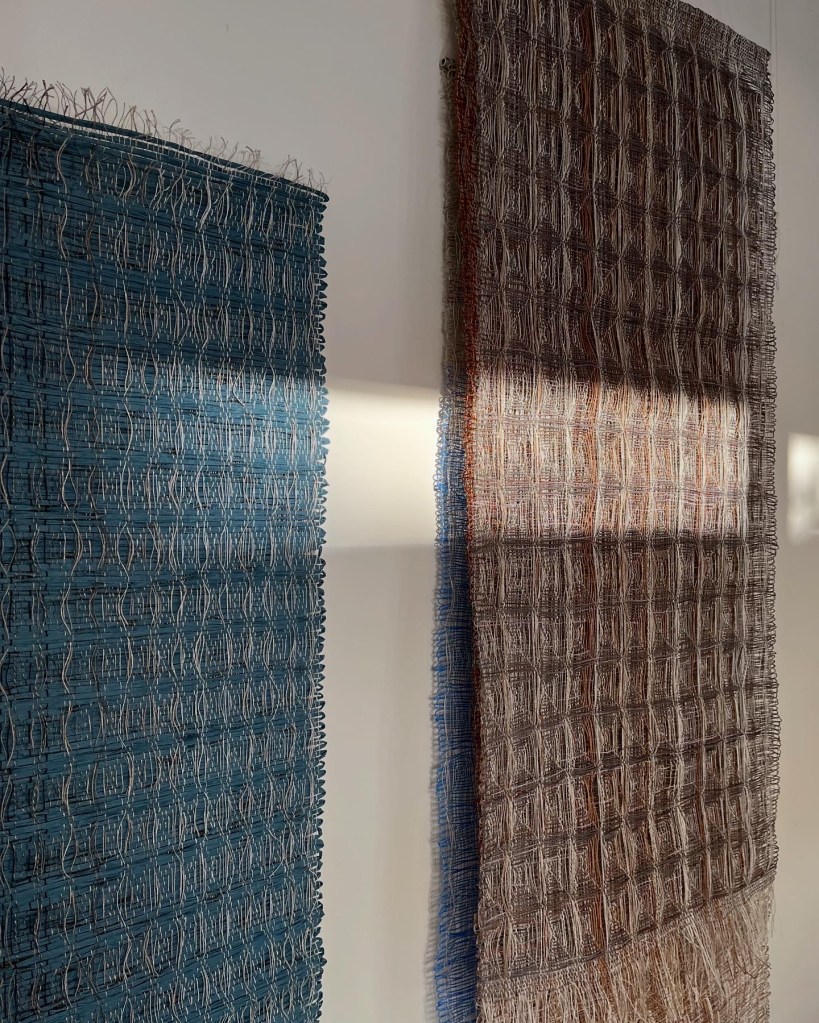 Woven wall hangings in afternoon sunshine