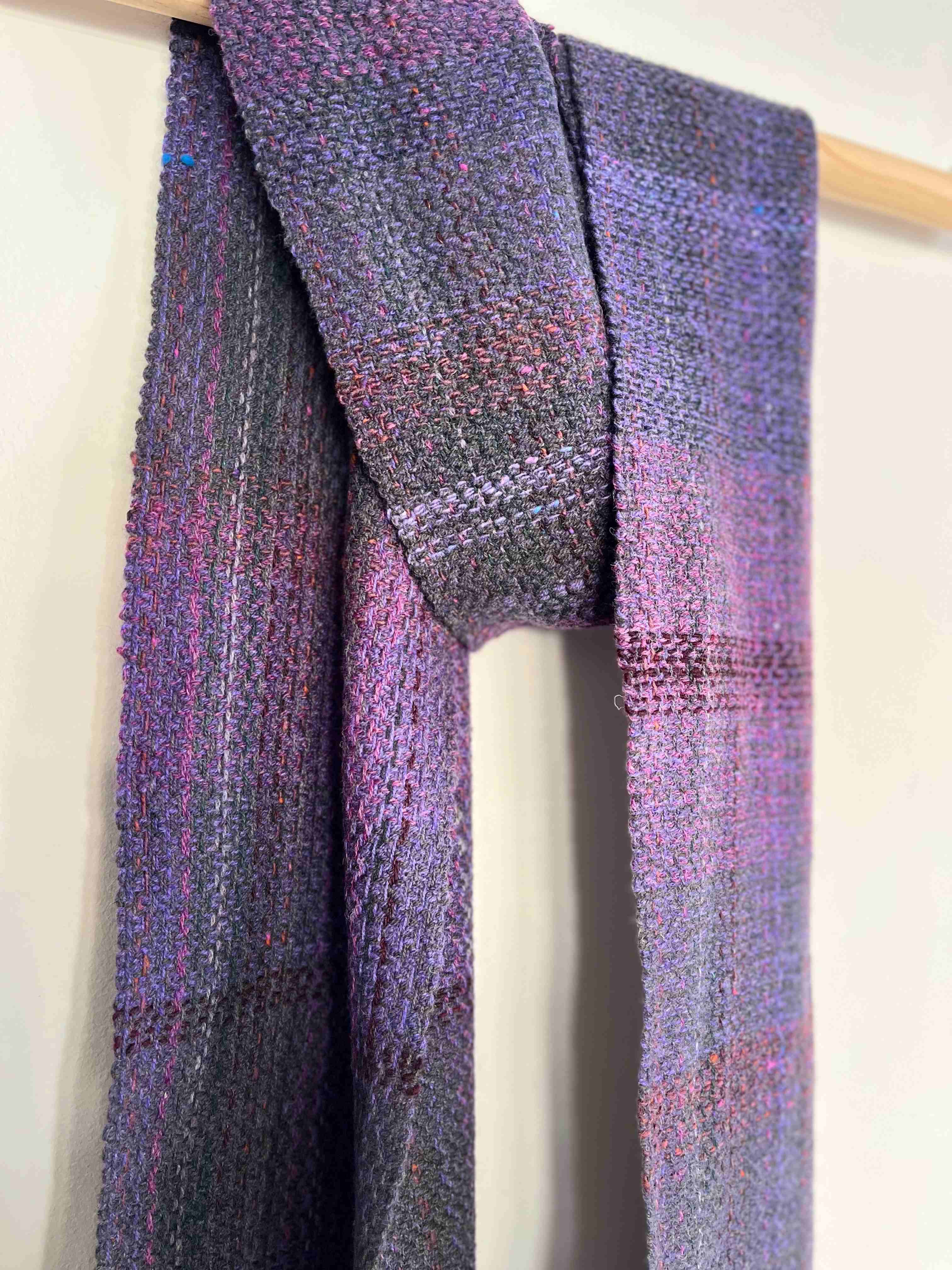 Commissioned purple scarf hanging from baton