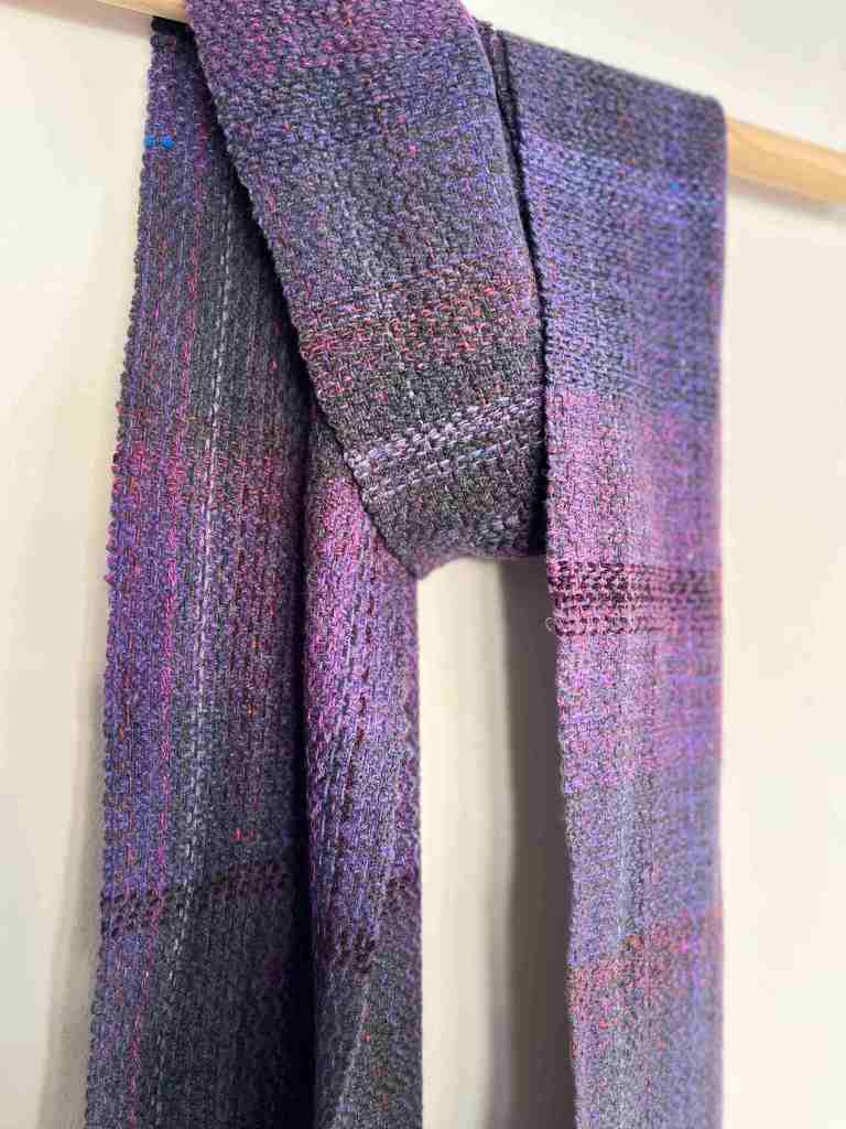 Commissioned purple scarf hanging from baton