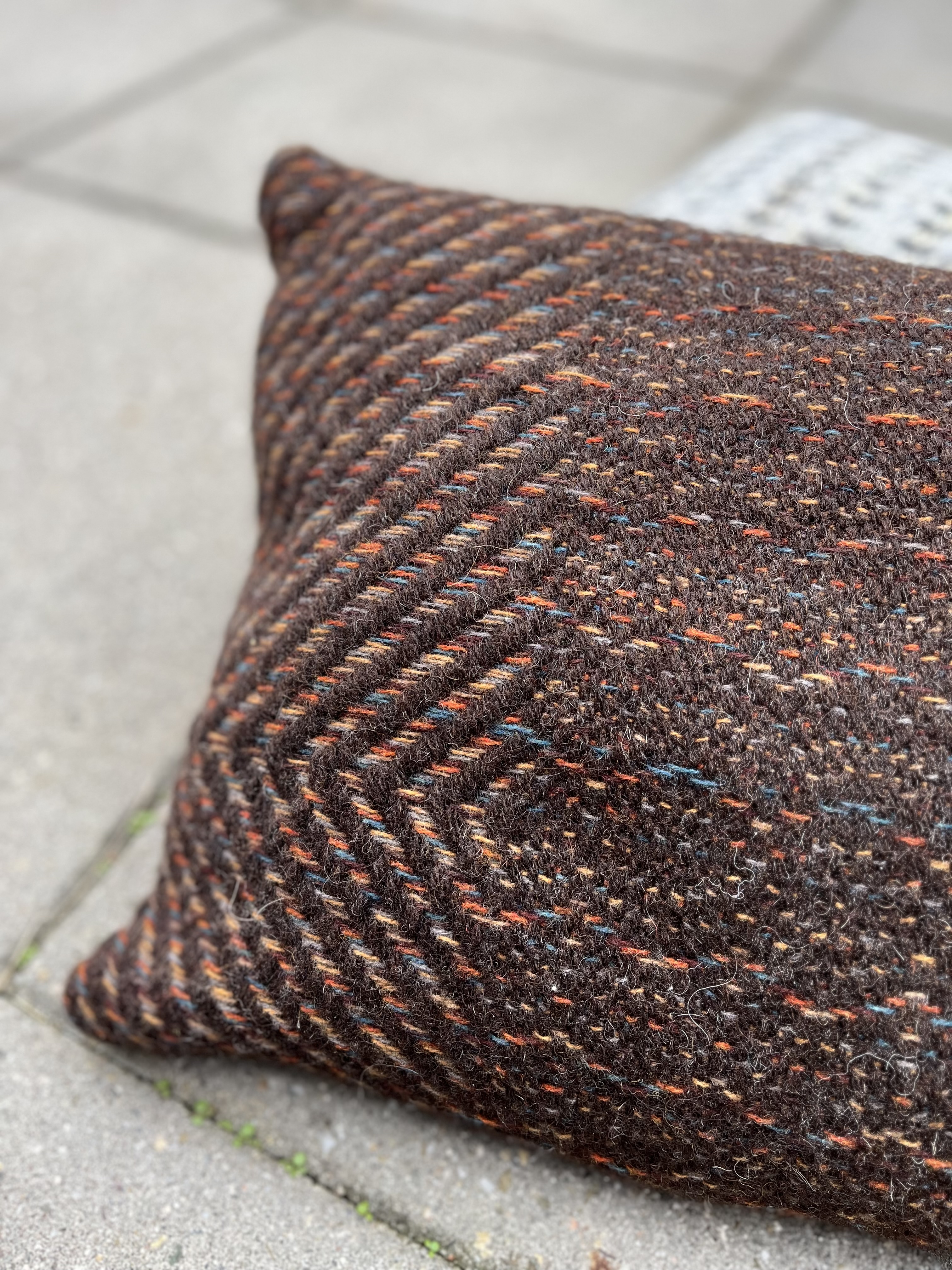 Unique locally grown wool woven into dark brown rustic cushion