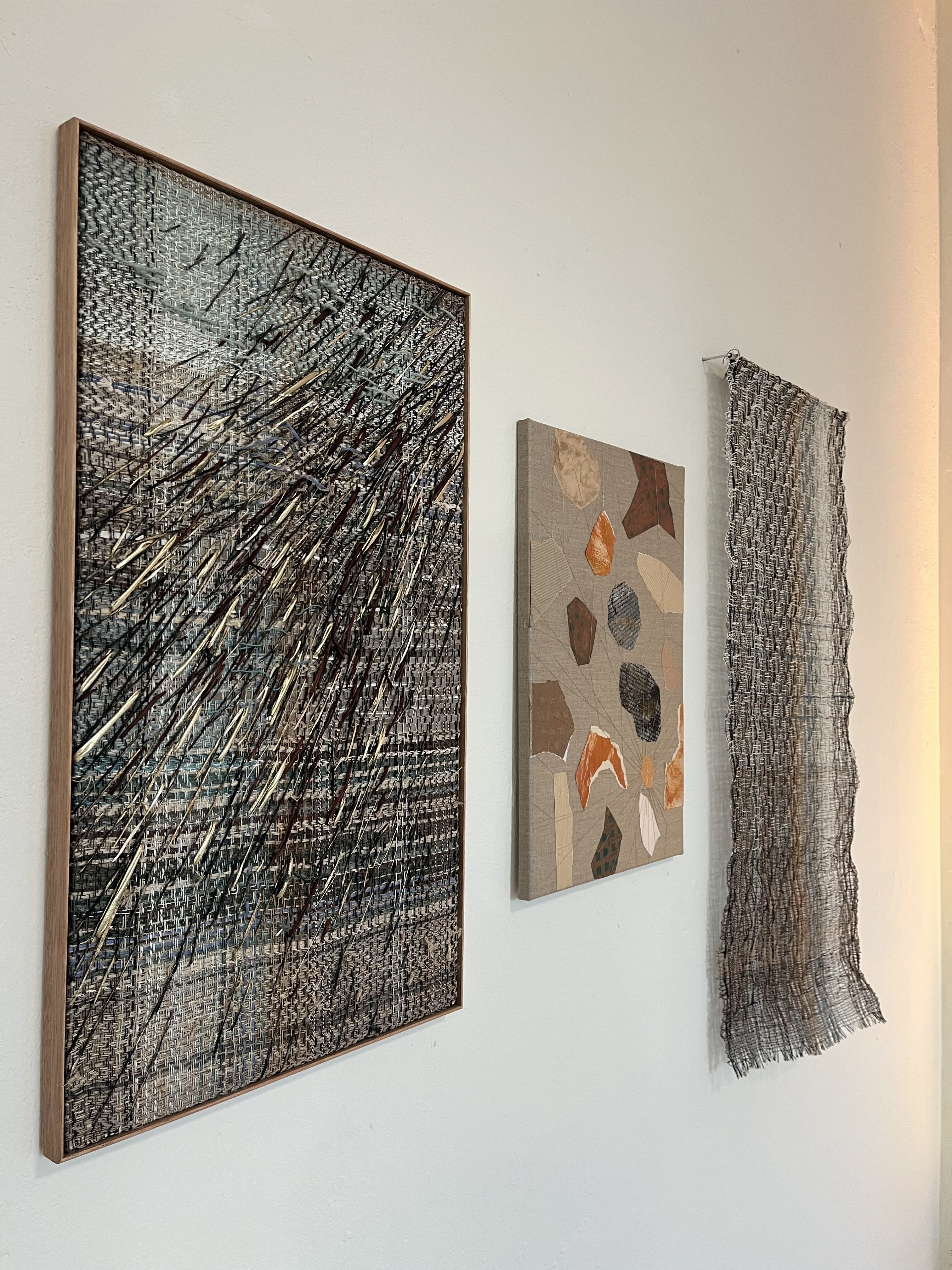 Woven and mixed media pieces on display