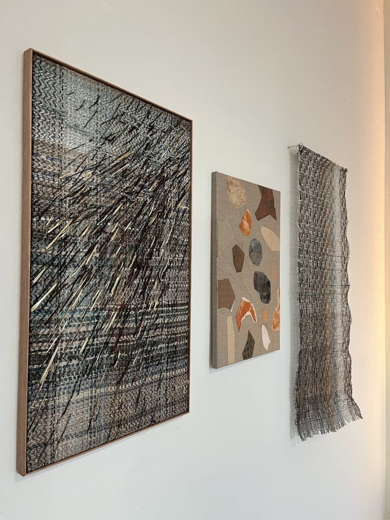 Woven and mixed media pieces on display